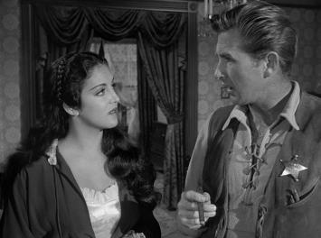Ramirez with Harvey Pell (Lloyd Bridges), whom she later breaks up with, calling him a boy and not a man when he refuses to help the Marshal save the town.